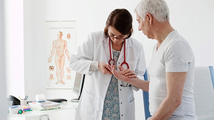 Rheumatologist checking a patient in an appointment