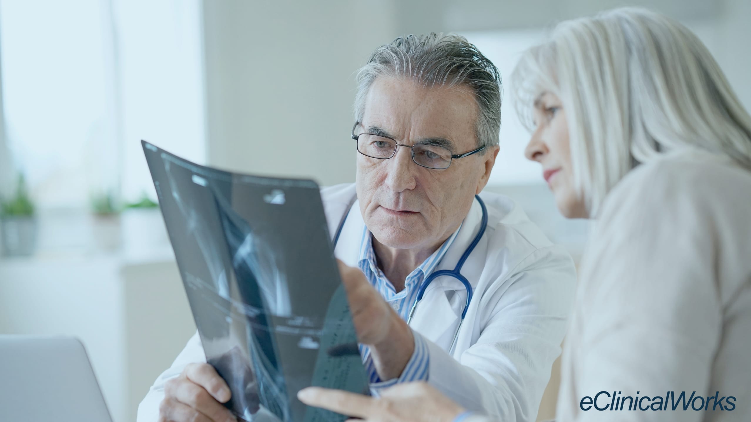 Rheumatologist looking at an xray with a patient