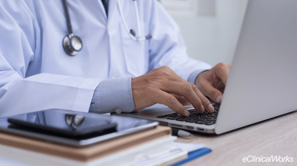 doctor typing on a laptop computer